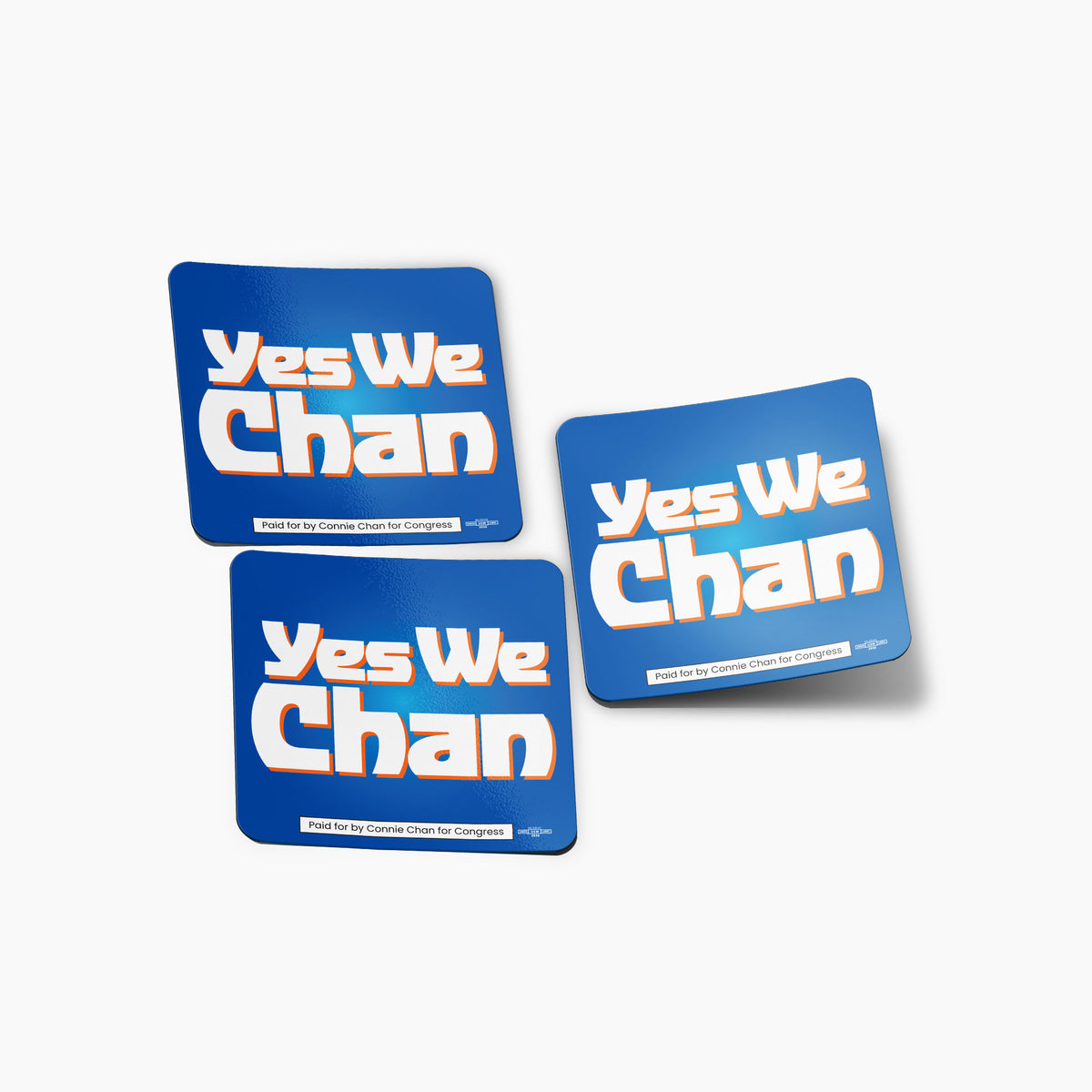 Three blue rectangular stickers with bold white and orange text reading "Yes We Chan".